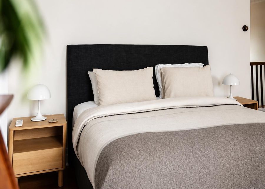 Spacious bedroom with comfortable bedding and bedside tables