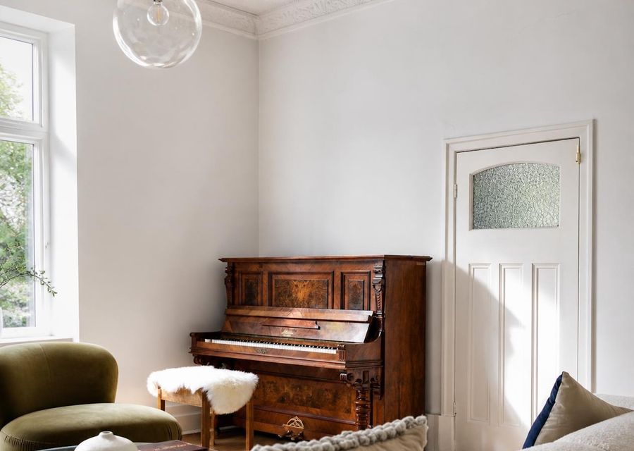 Character-filled sitting area featuring a classic upright piano