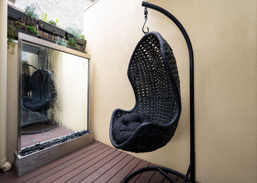 Enjoy a peaceful space in this egg chair and water feature