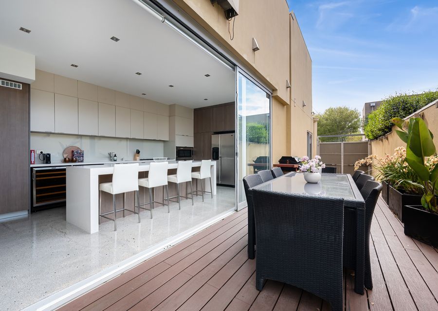 Indoor-outdoor perfection! The fully-equipped gourmet kitchen flows directly onto the private terrace, complete with a BBQ and outdoor dining set.