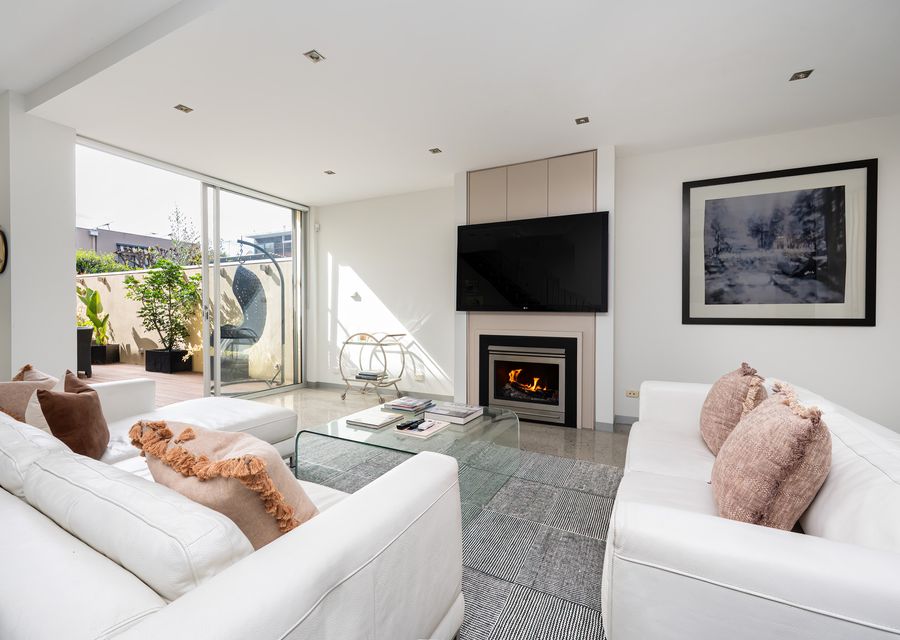 Light bright living room with fireplace and smart TV