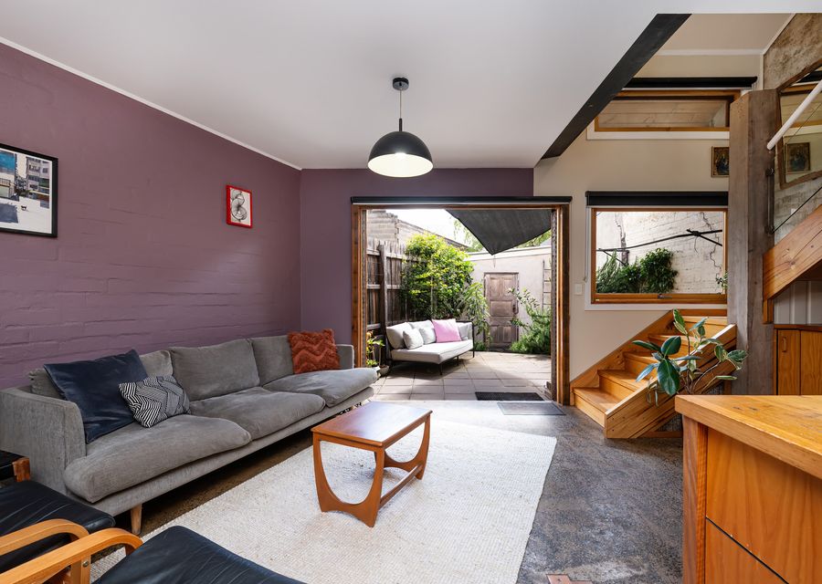 open-plan space features a comfy sofa, smart TV, and direct access to your own private outdoor patio