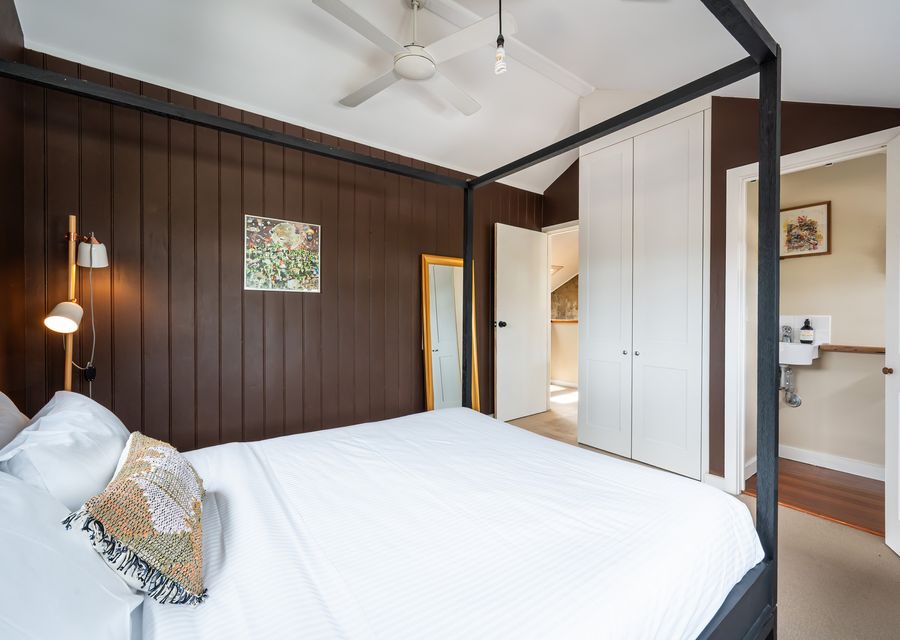 Master bedroom with Queen bed and ceiling fan and builtin robes.