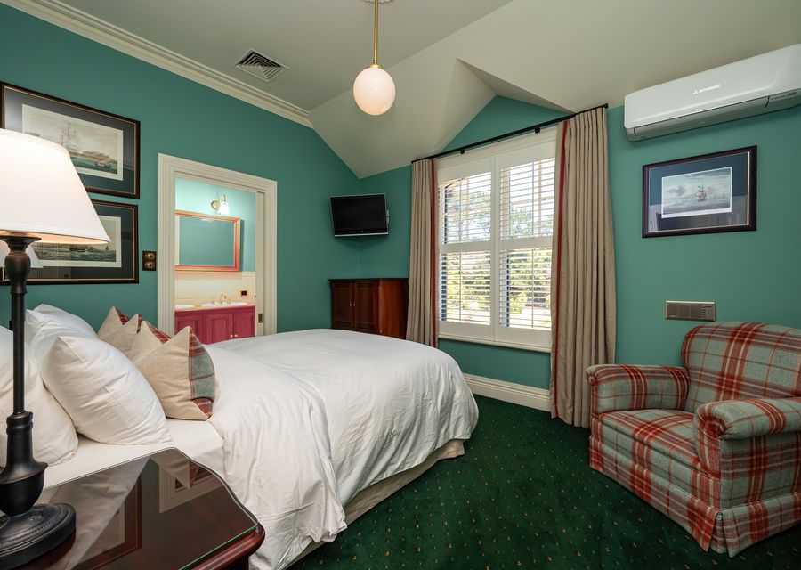 Bedroom three with its queen  bed and solo couch 