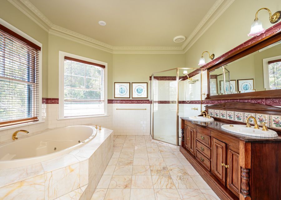 First ensuite bathroom with tub, shower and toilet 