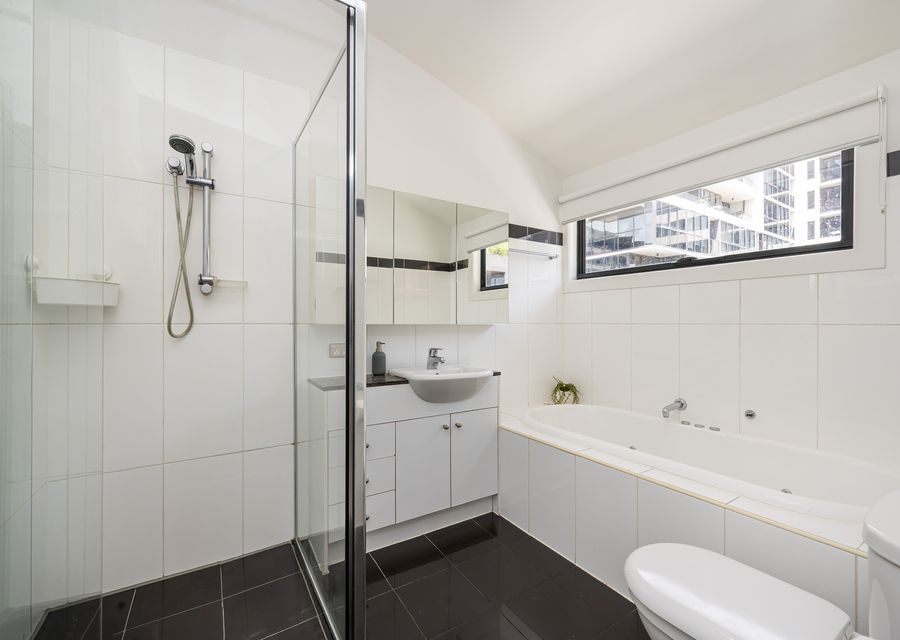 Upstairs bathroom with spa bath, walk in shower, vanity and toilet