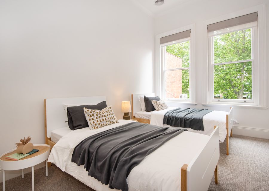 Bedroom one with 2 king single beds