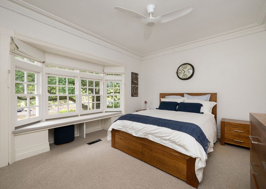 Bedroom 2 with Queen bed, ceiling fan and window seating