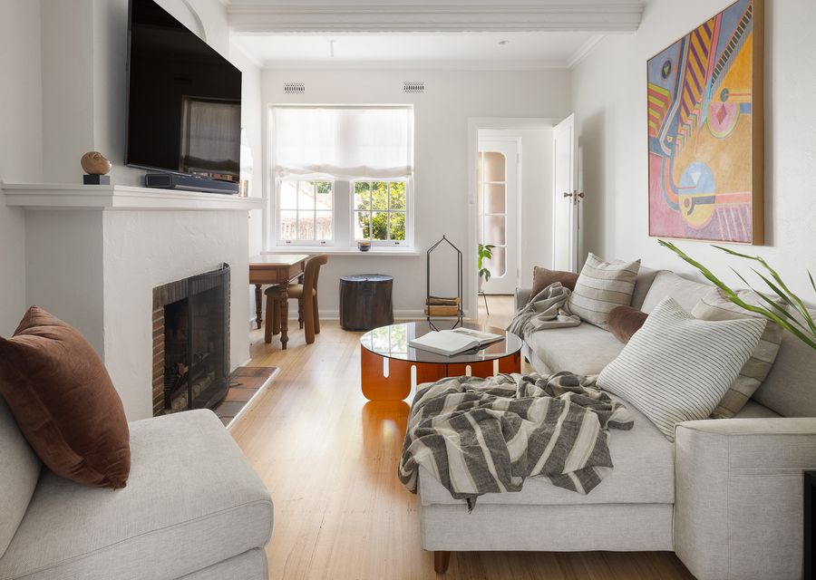 Light-filled living room, cozy fireplace, smart tv, comfortable lounge seating.