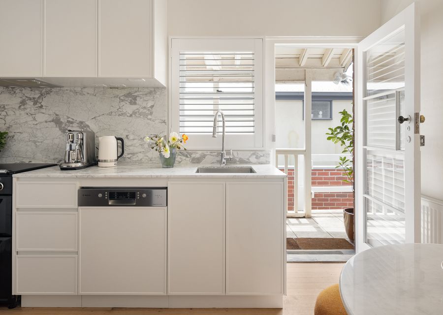 Kitchen with door leading out onto a shared balcony