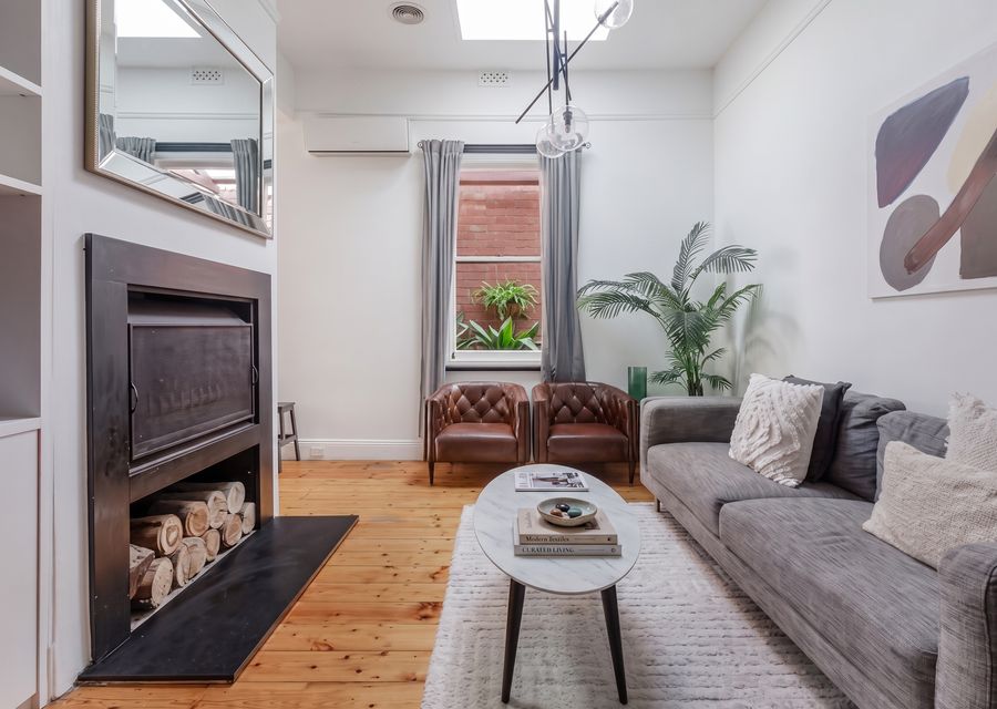 Living space with bright skylights up above, split system and ceiling fan