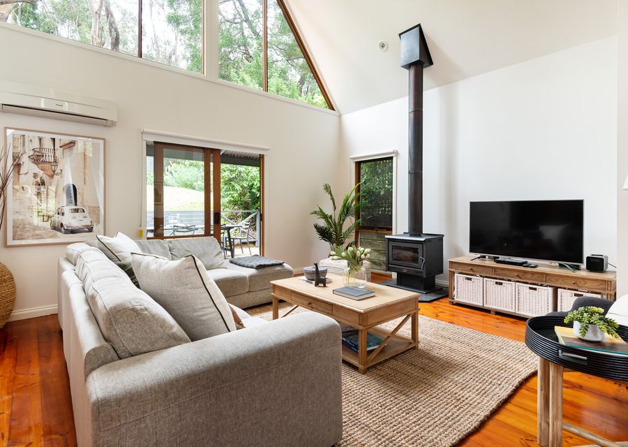 Relaxing lounge area with open fire and treetop views