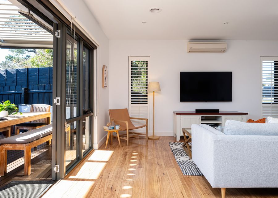 Living room with smart TV and access to outdoor dining area
