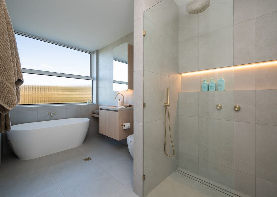 Main bathroom with tub, shower, and toilet