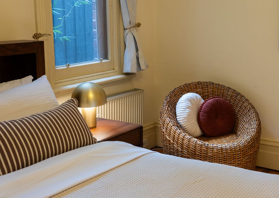 Relaxing bedroom corner with wicker chair