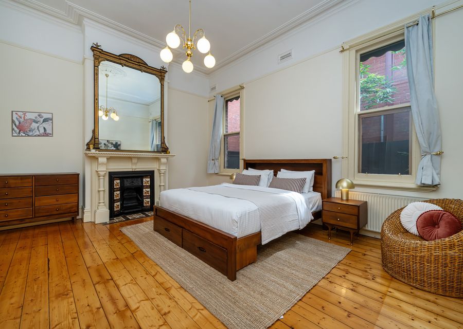 Elegant bedroom with ornamental fireplace.