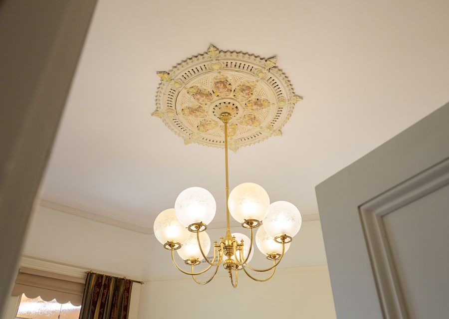 Elegant chandelier and ornate ceiling detail