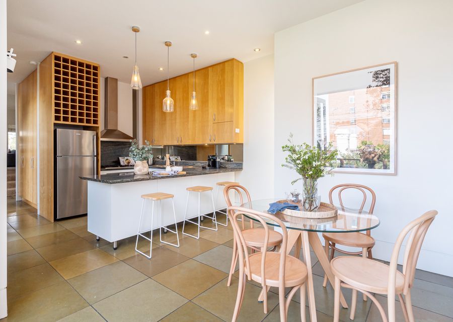 Kitchen with breakfast bar seating and meals area