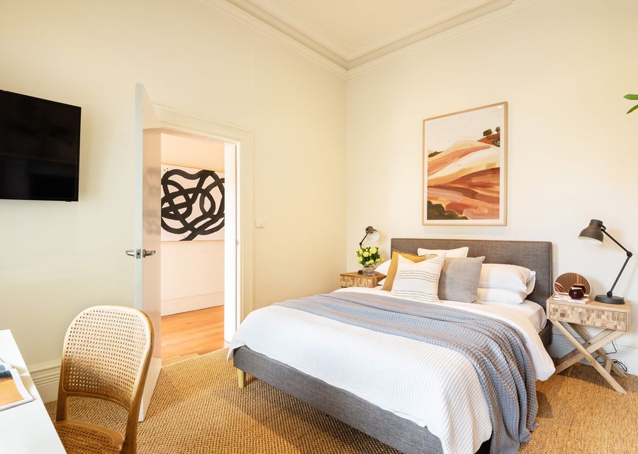 Front bedroom with Queen bed, smart TV and dedicated workspace