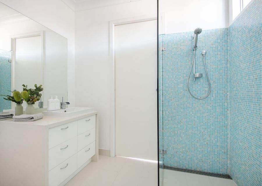 Downstairs bathroom with walk in shower and large single vanity and separate toilet