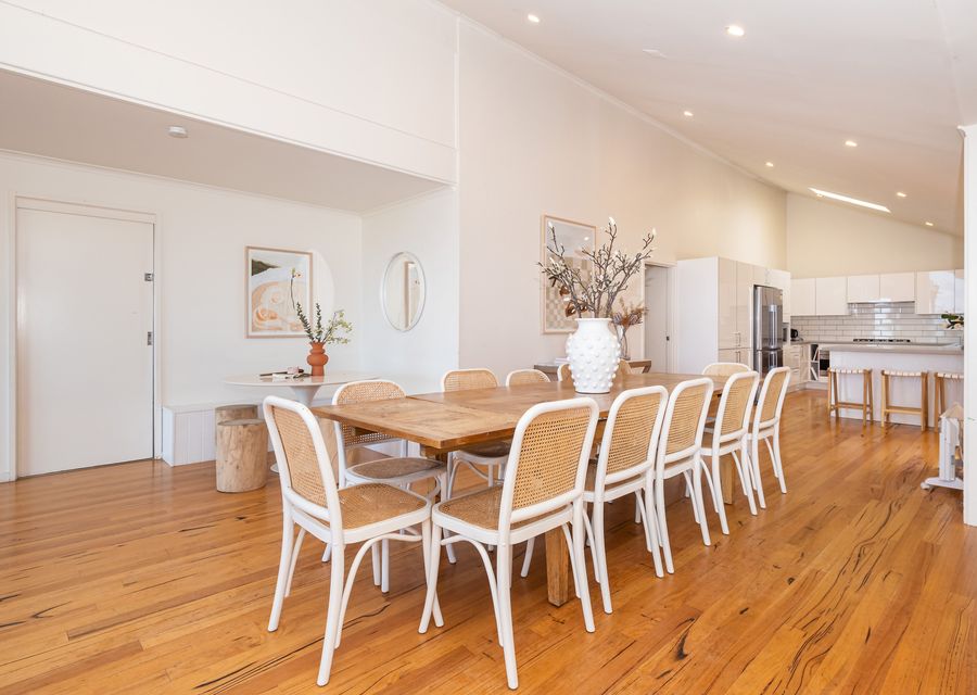 A spacious dining table takes center stage, adorned with tasteful decor.
