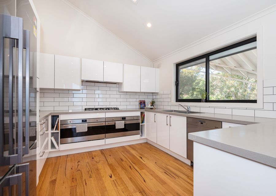 The kitchen, a chef's dream, features modern appliances and sleek countertops, providing ample space for meal preparation and culinary creations.