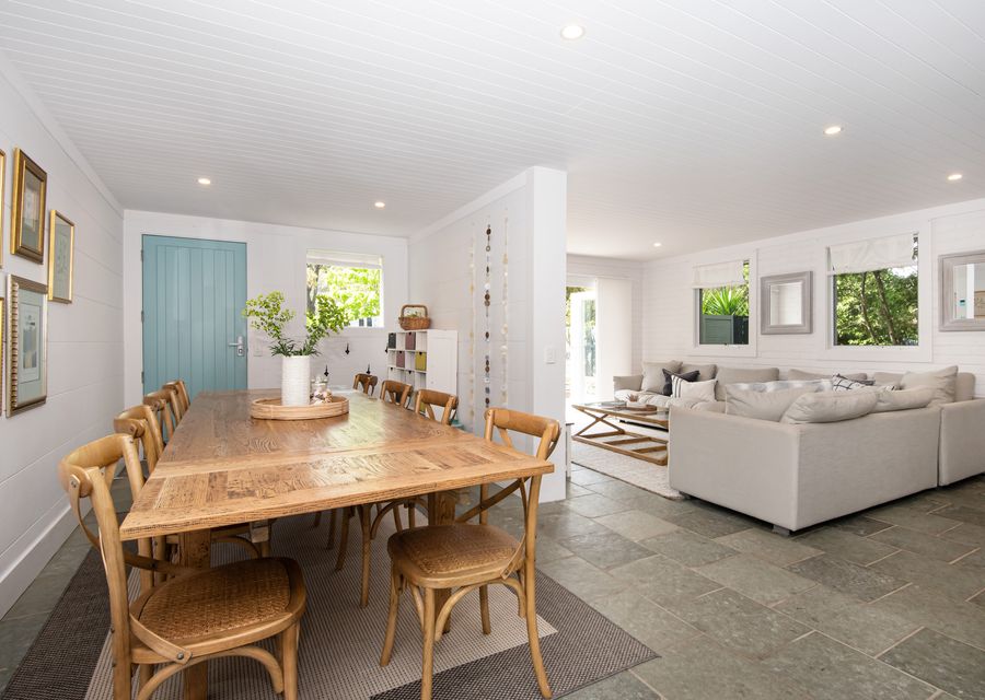 Main entrance with large dining, living leading out to courtyard and kitchen. There is alos a powder room on this level