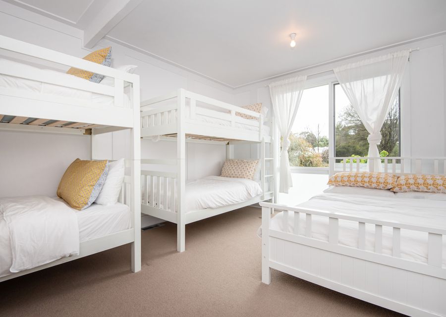 Bedroom four with double bed and two single beds