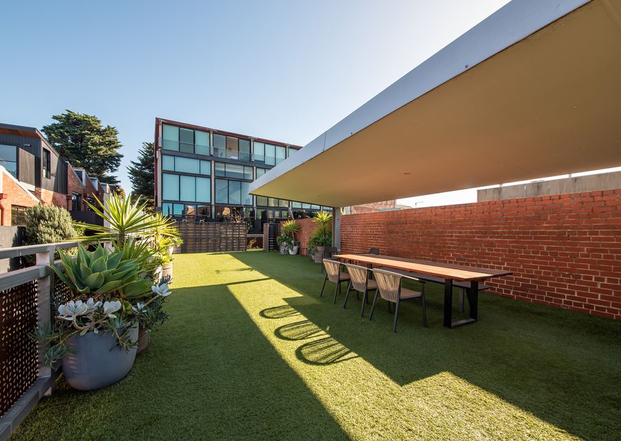 Communal outdoor dining with shared BBQ and pool.