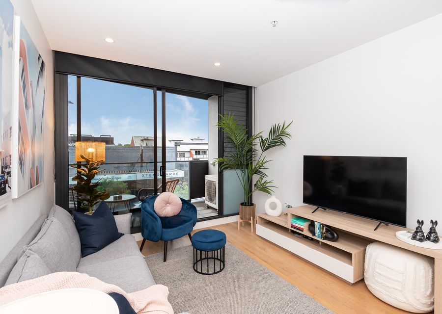 Living room with balcony access and smart TV