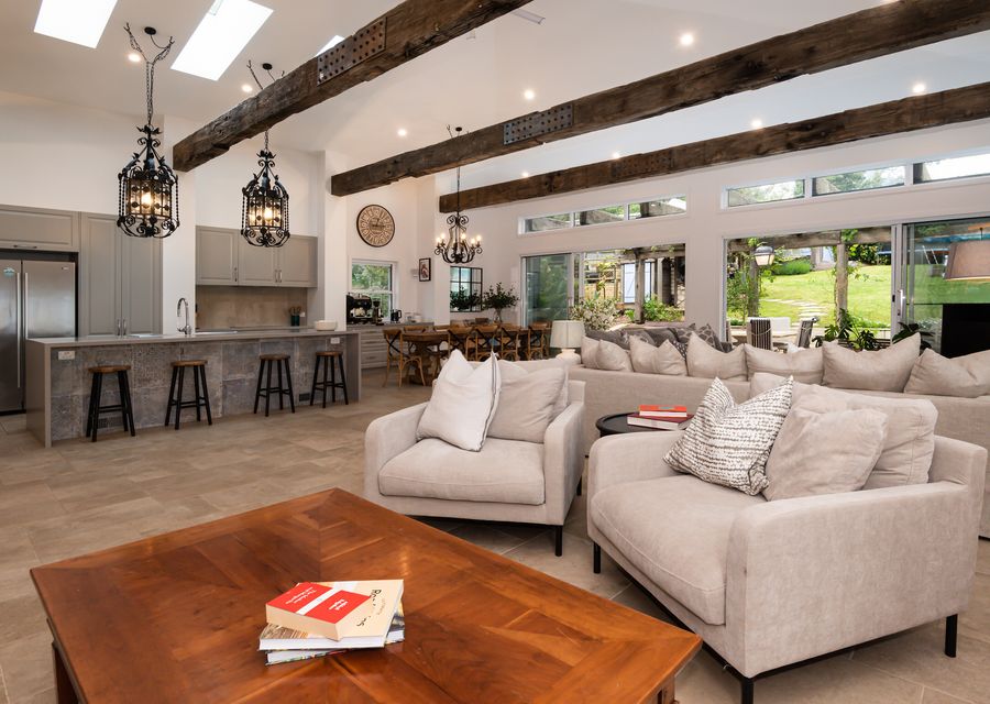 Main lving with stunning kitchen, wood fireplace and leading out to patio 