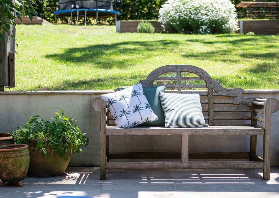 Enjoy the outdoor furniture, which offers a picturesque setting against the backdrop of lush greenery.