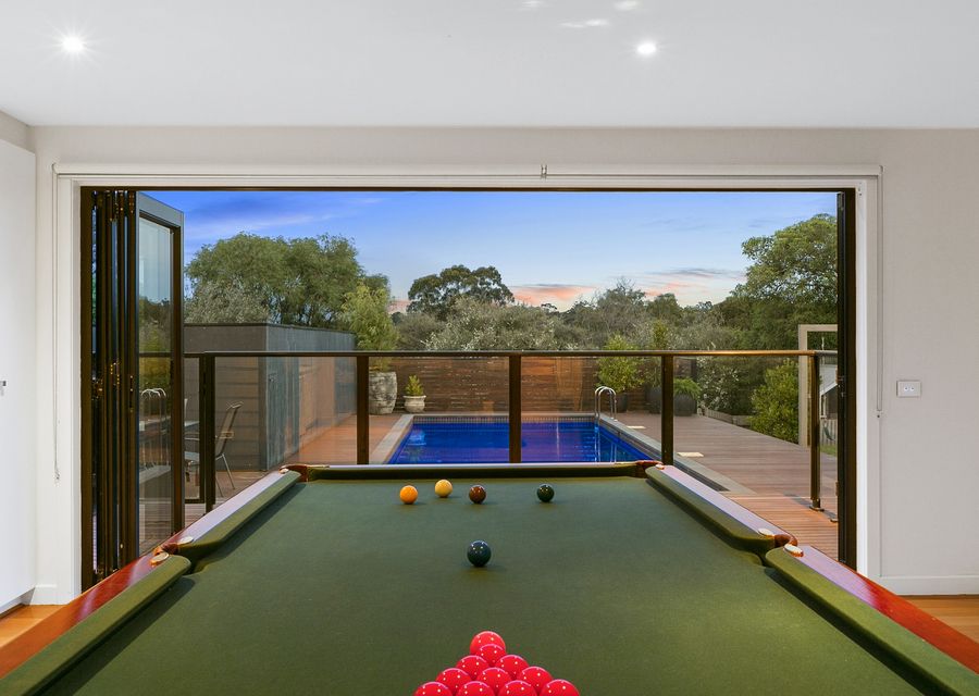 Full sized billiard table opening out to solar heated pool