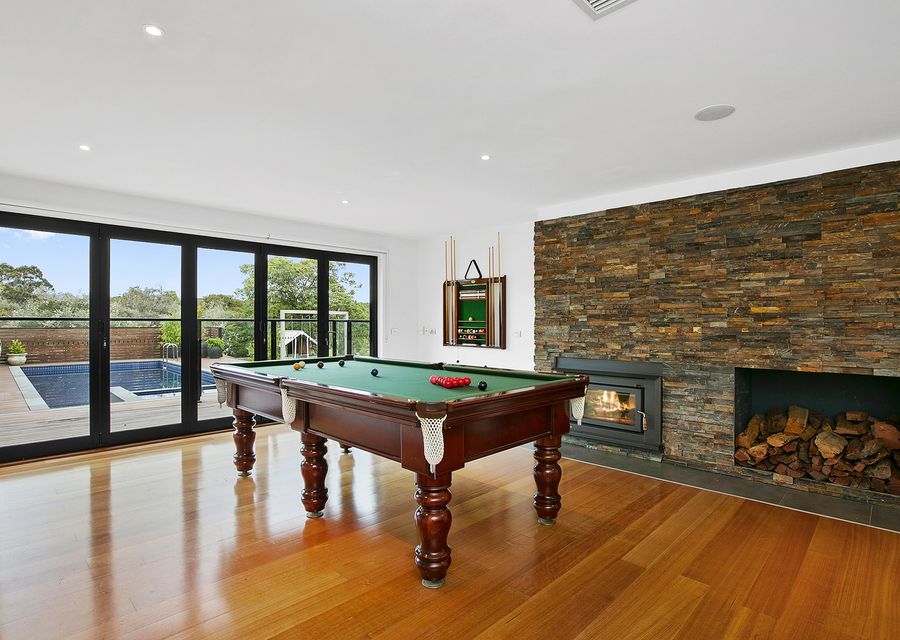 Second living space with a full sized billiard table and smart TV