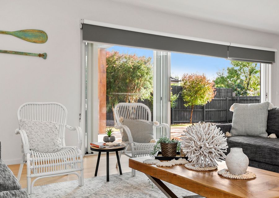 Living area with bi-fold doors leading to outdoor entertaining area