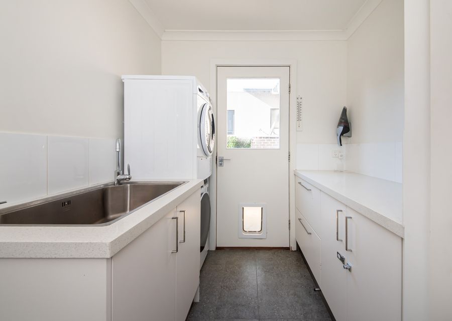 Laundry with washing machine and dryer and courtyard access