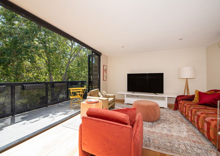 Living room with an abundance of natural light and balcony