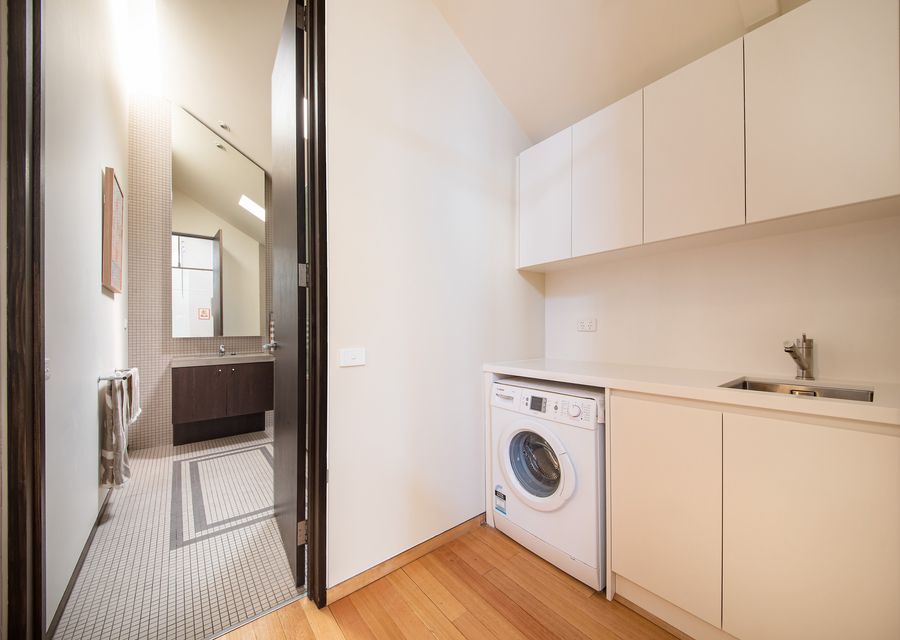 Laundry with bathroom entrance