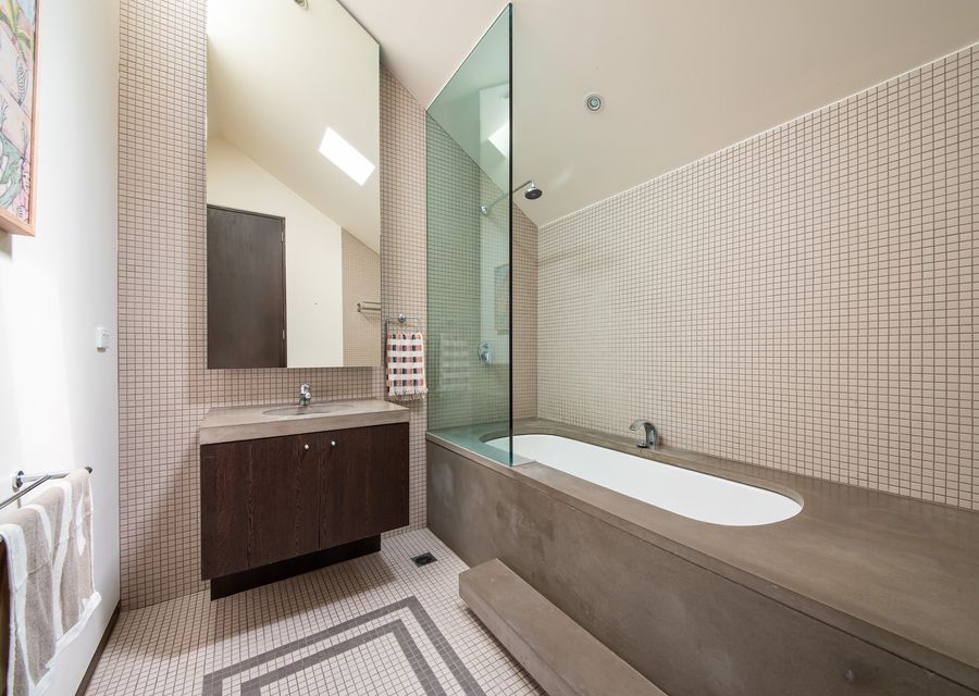 Main bathroom with bath and shower over bath