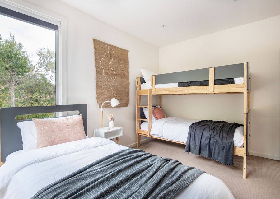 Bedroom with single bunk and single bed with a trundle 