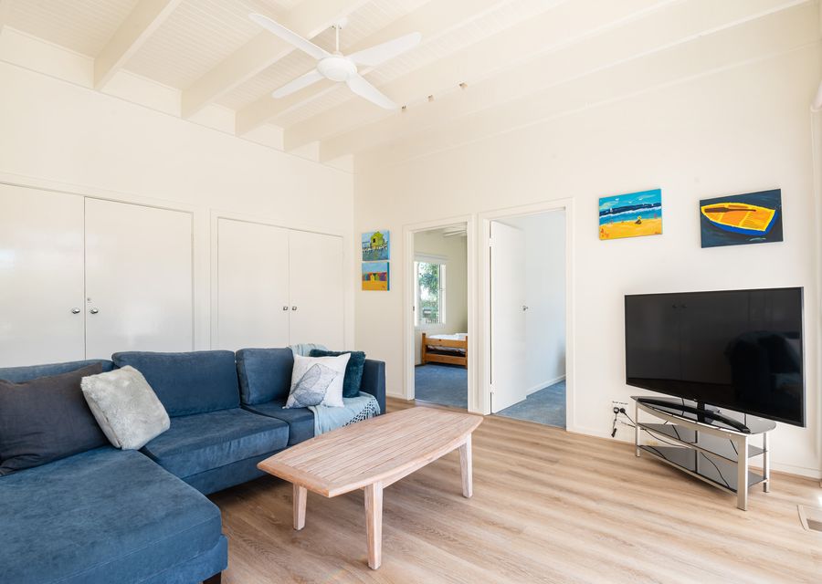 The living room is spacious and has a smart TV 