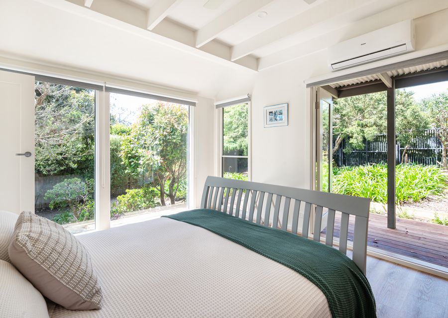 Bedroom one has a queen bed and has a split-type air conditioner