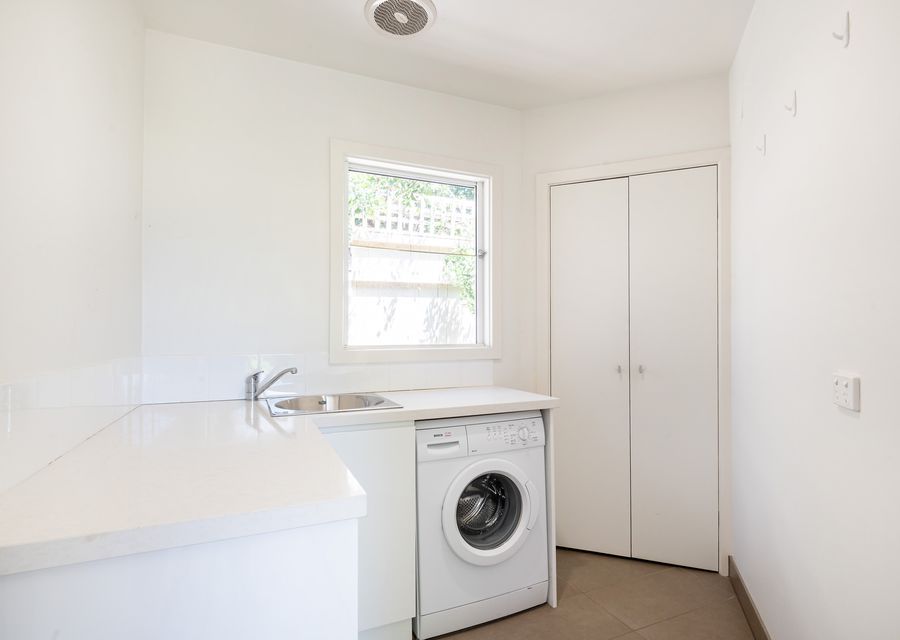 A mini-laundry room with washing machine and dryer