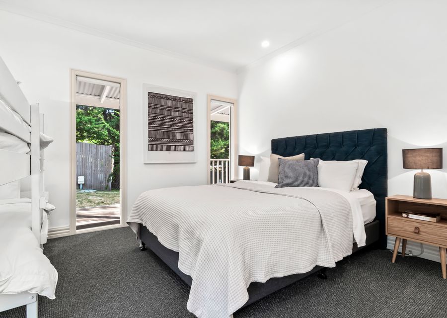 Bedroom Six with queen bed, single low bunk and single bed 