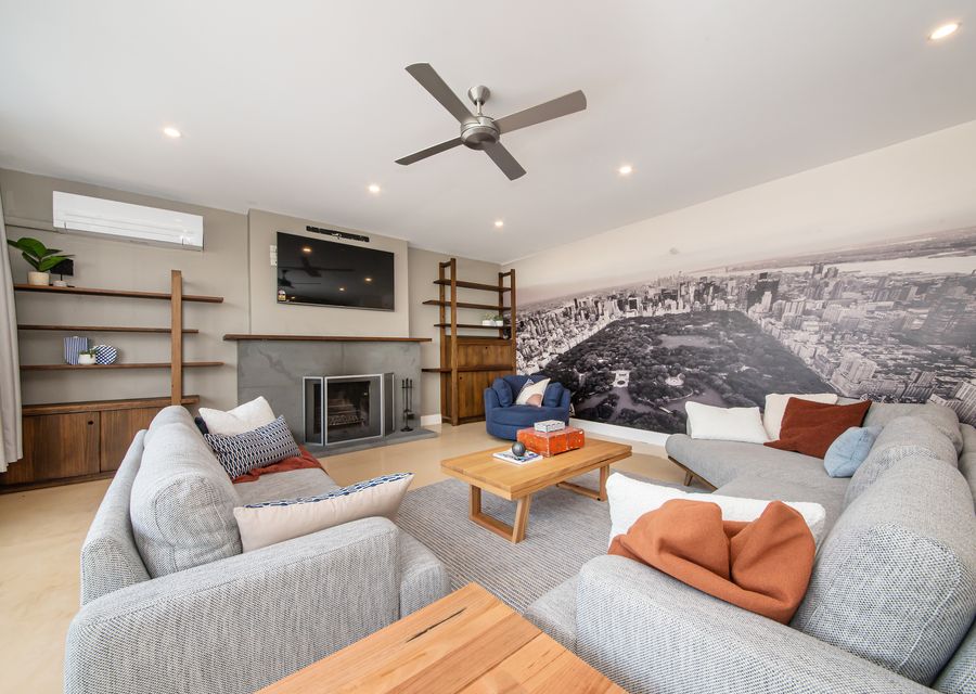 City skyline on the wall with ceiling, fan, split system and working fire place