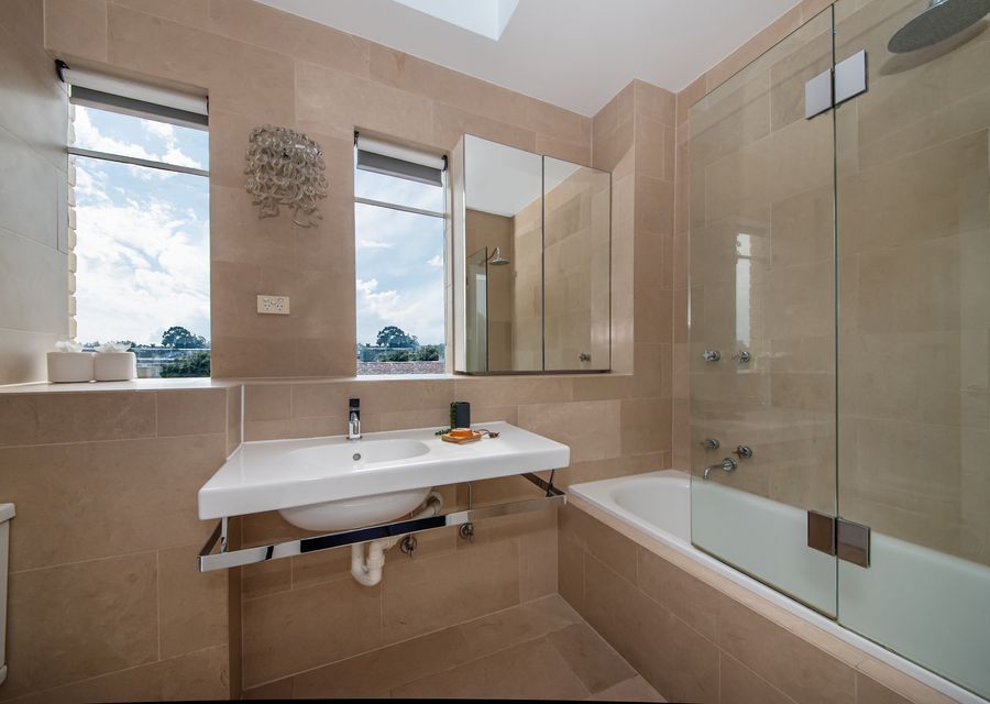 Main bathroom with bath and shower over bath