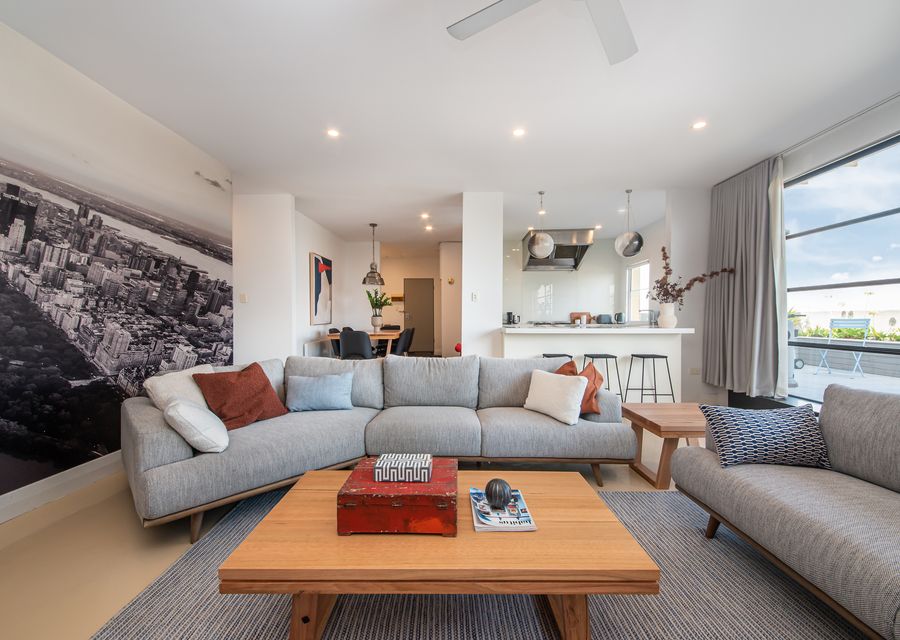 Spacious living area looking out onto the kitchen and dining