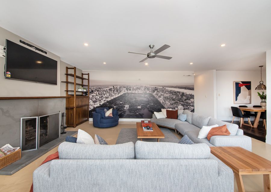 Open plan living and dining with smart TV and operational fireplace