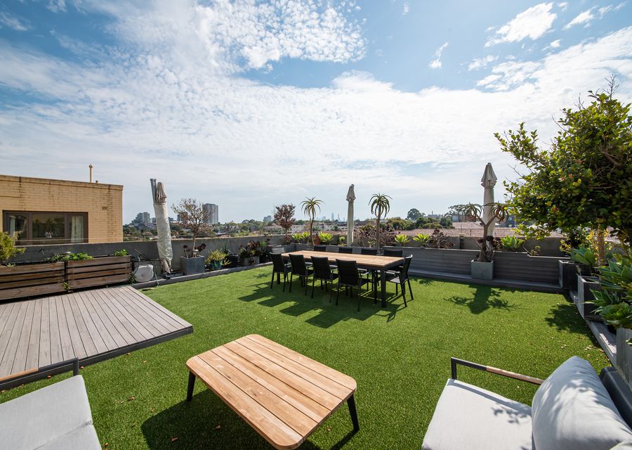 Private rooftop garden with seating and BBQ
