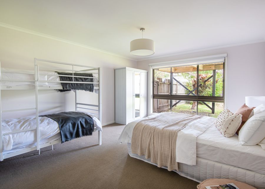 Downstairs bedroom with king bed and single bunk 